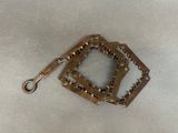 a small metal object with a chain attached to it