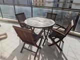 a table and chairs on the balcony of a building