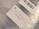 two tags on a piece of plastic that is wrapped in plastic
