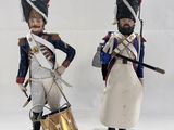 two figurines of soldiers with drums and drums on wooden bases
