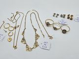 a group of jewelry including rings, necklaces, and earrings