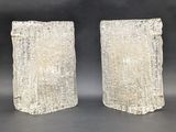 pair of carved stone bookends on a black background