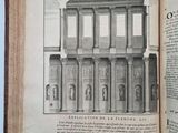 an open book with a drawing of a building on it
