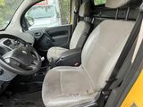 a yellow truck with a black seat and a black steering wheel