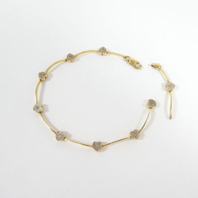 a gold and diamond necklace on a white background