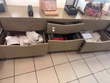 a desk with two drawers and a phone on it