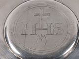 a silver plate with a cross on it