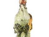 a figurine of a chicken on a plate