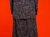 an image of a woman ' s coat and dress on a mannequin stand