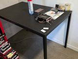 a black table with a bottle on top of it