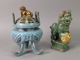 two small statues of lions and a lion on a pedestal