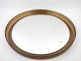 brown and white round mirror on a white surface