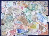 many different types of foreign currency on the table