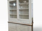 a white china cabinet with glass doors and a wooden top