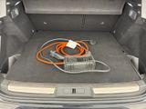 a trunk of a car with an electric charger in it
