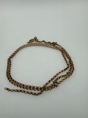a close up of a chain with a clasp on a white surface