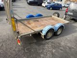 a trailer with a flat bed in a parking lot