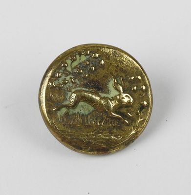 a close up of a gold coin with a rabbit on it