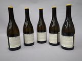 four bottles of wine are lined up in a row