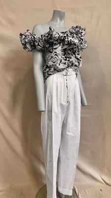an image of a mannequin dressed in white pants and a black and white top