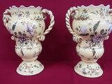 two vases that are sitting on a table