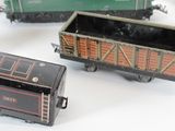 many toy trains that are sitting on a white surface