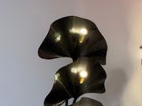 a lamp that is sitting on a table next to a plant