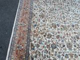 a large rug on the ground with a cat on it