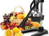 a juicer that is sitting next to a basket of fruit