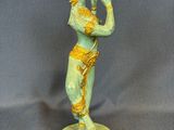 an image of a statue of a woman playing a flute