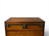 an old wooden trunk sitting on top of a white surface