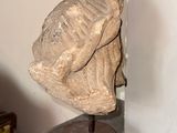 a statue of a man with a hat on top of a table