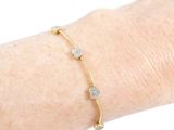 a close up of a person ' s arm with a bracelet on it
