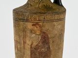 a black and gold vase with a painting on it
