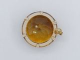 a close up of a ring with a yellow stone in it
