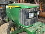 a close up of a green tractor in a garage