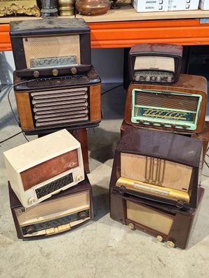 several old fashioned radio ' s are stacked on top of each other