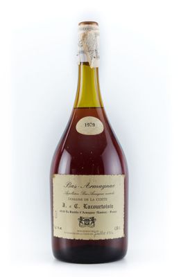 une vieille bouteille de vin posée sur une surface blanche