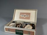 a box with a variety of items in it on a table
