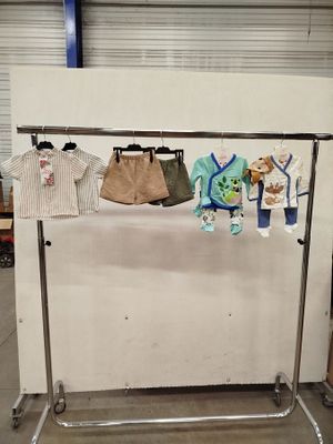 an image of a clothes rack with clothes hanging on it