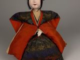 an antique doll of a woman in a kimono dress