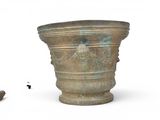 a large vase and a cigar on a white surface