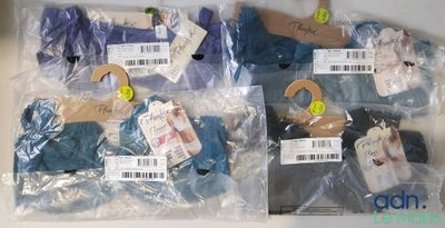 quatre sacs de vêtements emballés dans du plastique
