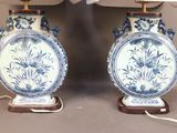two blue and white vases sitting on a table