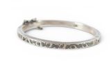 a close up of a silver ring on a white surface