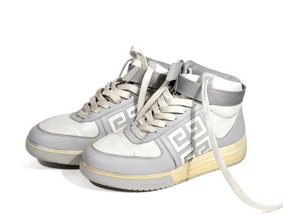 grey and white high top sneakers with a white and grey logo on the sole