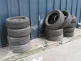 a lot of tires sitting on the side of a building
