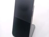 a cell phone that is sitting on top of a stand