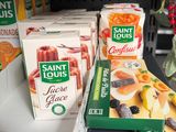 several boxes of fruit are sitting on a shelf in a store