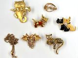 many different types of animal brooches on a white surface